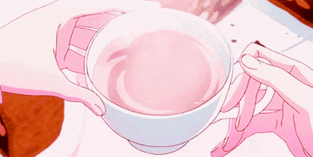 a person in pink holding a cup of pink liquid