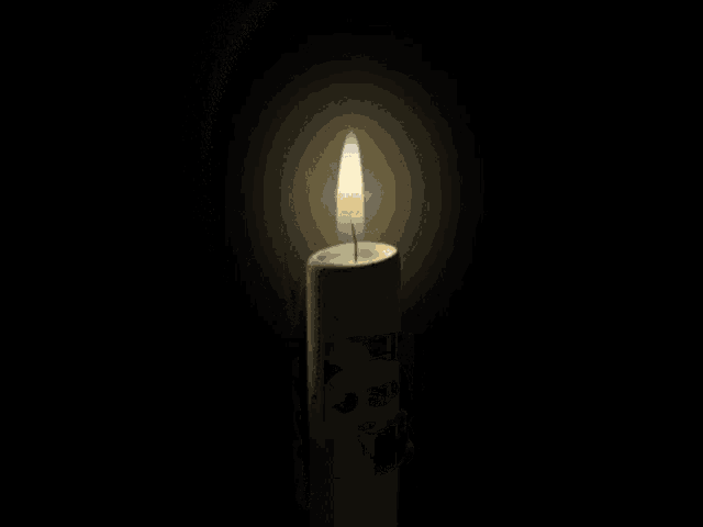 a white candle with a picture of a skull on it