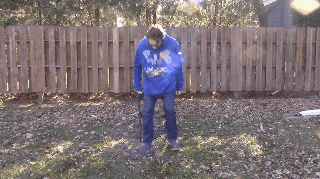 a person wearing a blue hoodie with the letter a on it