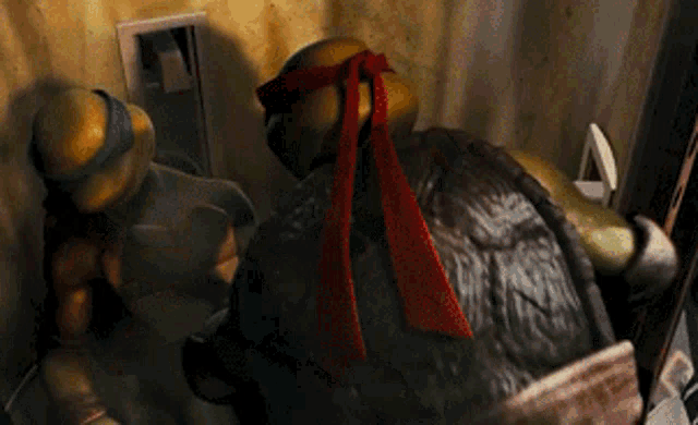 two teenage mutant ninja turtles are standing next to each other in a dark room