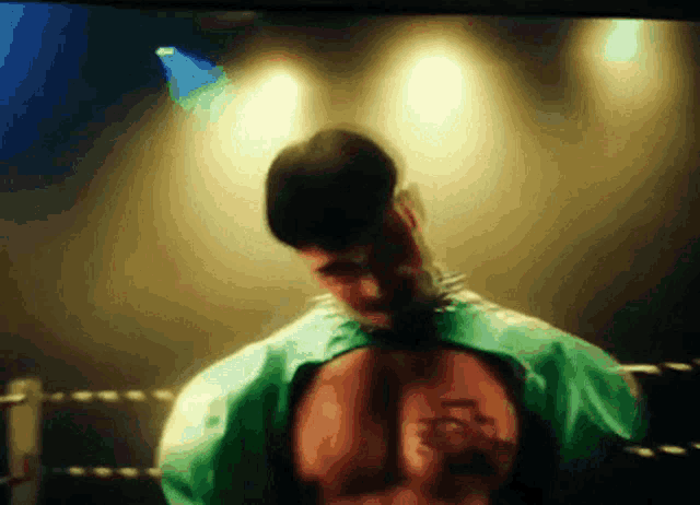 a blurry picture of a man with a green shirt on