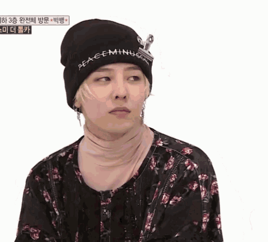 a man wearing a black beanie that says peace minus one on it