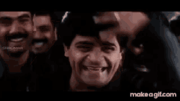 a group of men are smiling and laughing in a movie .
