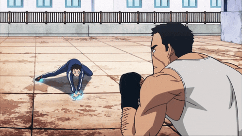 a man in a white tank top looks at a man doing a handstand