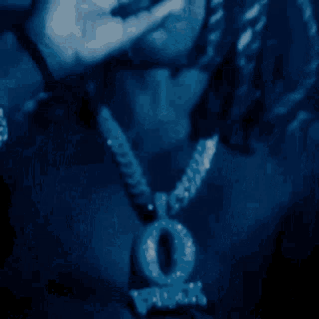 a close up of a person wearing a necklace