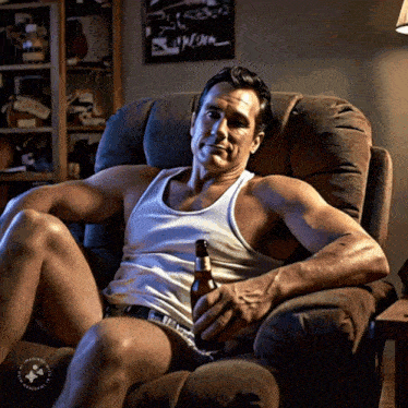 a man in a white tank top sits in a chair with a bottle of beer