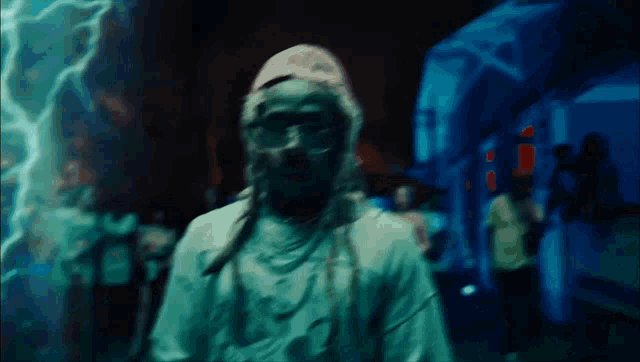 a blurry picture of a man with dreadlocks and a hat