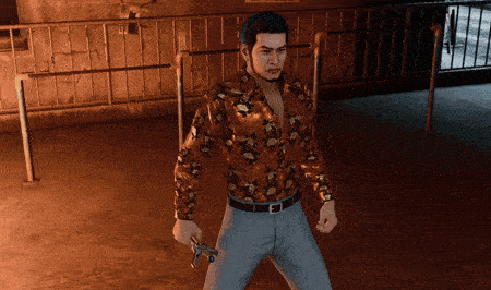 a man in a floral shirt is holding a gun in his hand