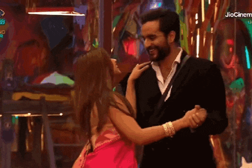 a man and woman are dancing in front of a jio cinema logo