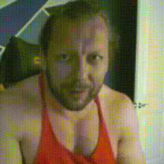 a man with a beard wearing a red tank top