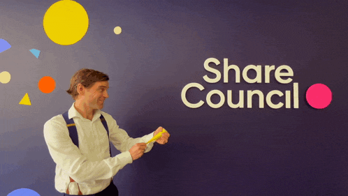 a man standing in front of a wall that says share council on it