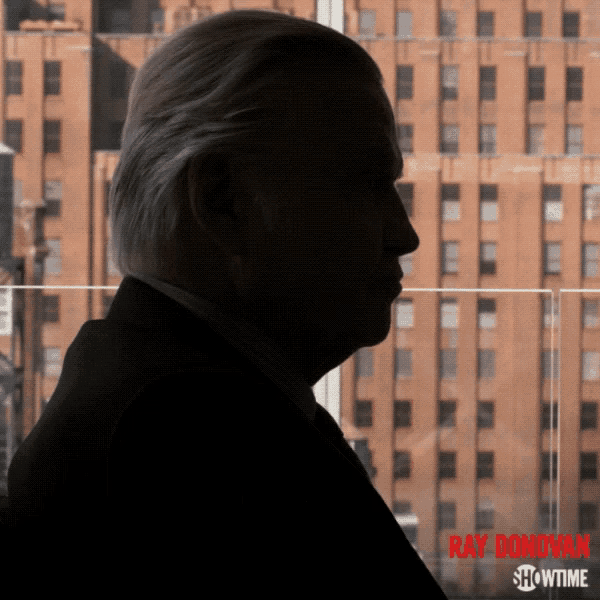 a poster for ray donovan showtime shows a man in a suit and tie