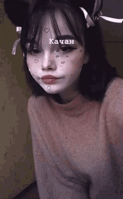 a girl wearing a cat ear headband has the word kachan above her face