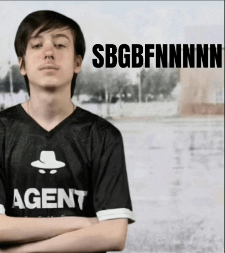 a man wearing a shirt that says agent with his arms crossed