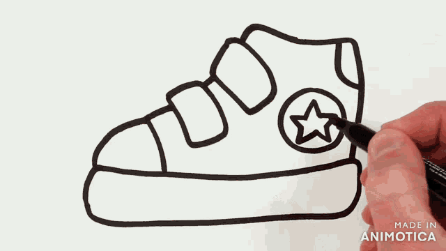 a person is drawing a shoe with a star on the side of it
