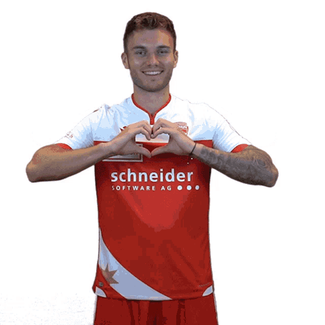 a man in a red and white schneider software ag shirt makes a heart shape with his hands