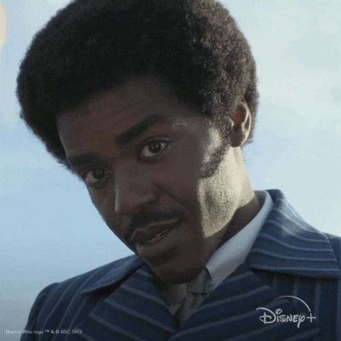 a close up of a man 's face with a disney logo on the bottom