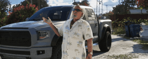 a man in a hawaiian shirt is standing in front of a ford truck