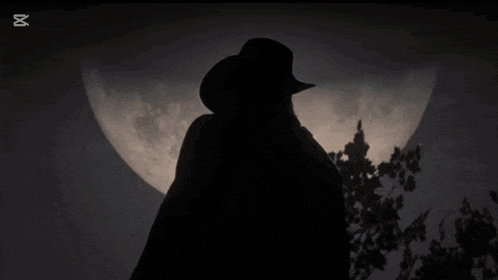 a silhouette of a man standing in front of a full moon with a capcut logo in the corner