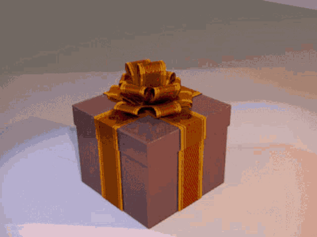 a gift box with a brown and gold ribbon and bow