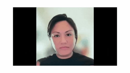 a close up of a woman 's face with a blurred background .