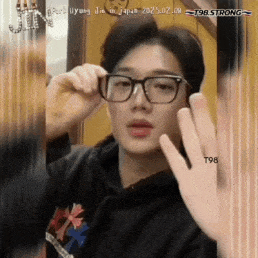 a man wearing glasses with a t98 strong watermark
