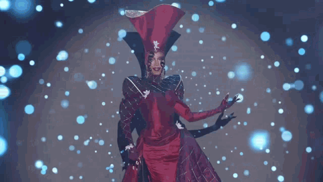 a woman in a red dress and hat is surrounded by blue circles