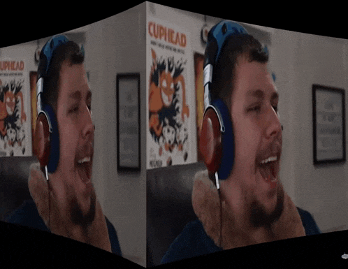 a man wearing headphones is screaming in front of a cuphead poster
