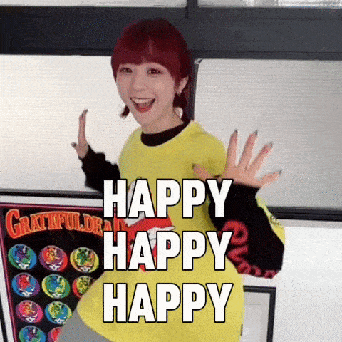 a girl with red hair is wearing a yellow shirt that says " happy happy happy "