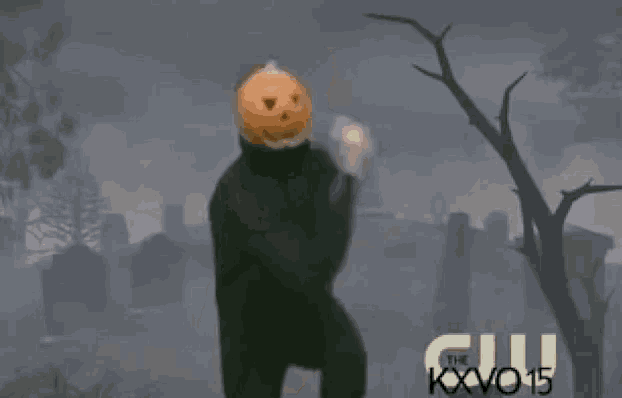 a man with a pumpkin on his head is dancing in a cemetery with the words pronti per la festa di halloween