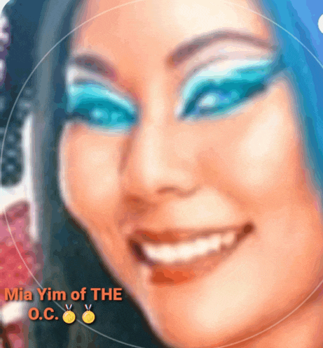 mia yim of the o.c. is smiling with blue eye makeup