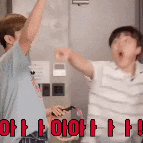 a couple of men are standing next to each other with their arms in the air and making funny faces .