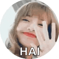 a girl is making a peace sign with her hand .
