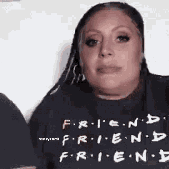 a woman is wearing a black t-shirt with the words `` friends '' written on it .