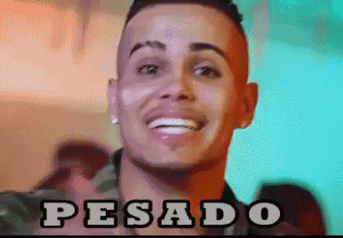 a close up of a man 's face with the word pesado written on it