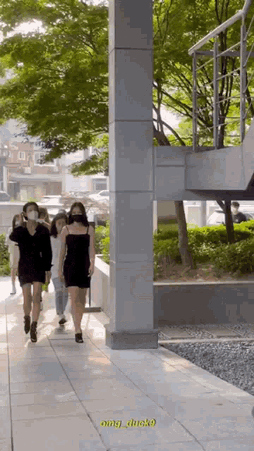 a woman in a black dress walks down a sidewalk with a caption that says omg_duck9
