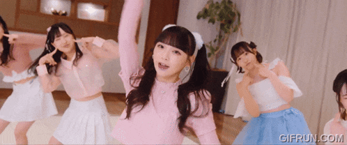 a girl in a pink top is surrounded by other girls