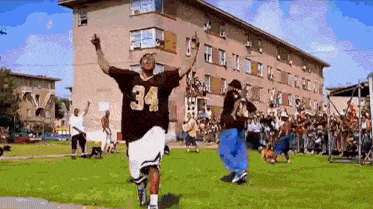 a man wearing a jersey with the number 34 on it is running in a field