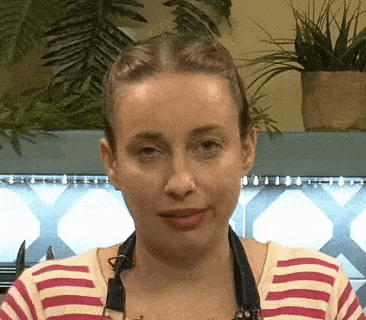 a woman in a striped shirt is looking at the camera .