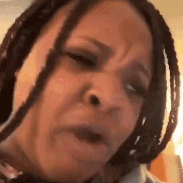 a close up of a woman making a funny face with her mouth open .