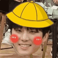 a person wearing a yellow hat with red cheeks