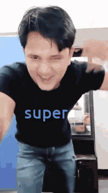 a man is wearing a black shirt that says super on it