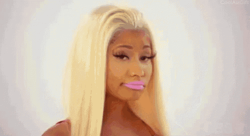 a woman with blonde hair and pink lips is wearing a pink lipstick .