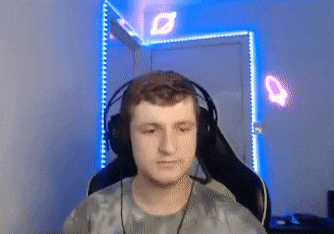 a man wearing headphones and a microphone is sitting in a chair .