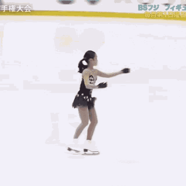 a woman in a black bikini is skating on a rink with chinese writing on it