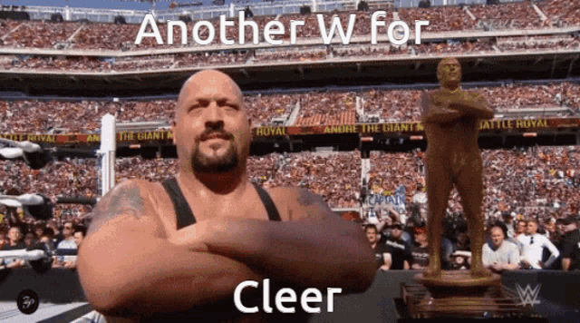 a man with his arms crossed stands in front of a crowd with the words " another w for clear " written above him