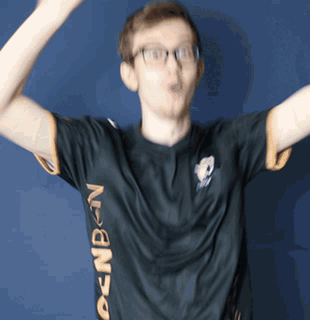 a young man wearing glasses and a black shirt that says denben