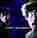 a blurry picture of a person 's face in a dark room with a blue background .