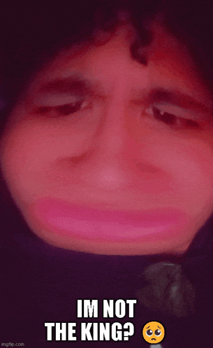 a close up of a person 's face with the words im not the king on the bottom