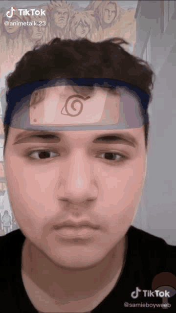 a man is wearing a headband with a naruto logo on it